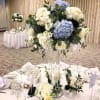 Pale blue and white hydrangeas form the heart of this tall, formal