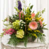 A lively basket of springtime joy, this mixed flower arrangement is the