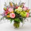 Bright, cheerful pink roses and pink lilies take center stage in this