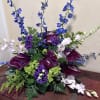 Purple and blue floral arrangement with tall spikes and dark calla lilies