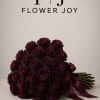 A dramatic arrangement of 50 deep burgundy roses, hand-tied with an elegant