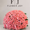 A luxurious arrangement of soft pink roses, beautifully gathered with delicate ribbon