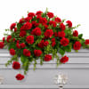 The Red Carnation Casket Spray  embodies a traditional tribute of deep