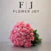 A beautiful bouquet of 50 vibrant pink roses, finished with elegant ribbon