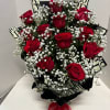 Bouquet of red roses with white baby's breath and black patterned wrap