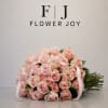 A graceful arrangement of soft blush-pink roses, hand-tied with delicate ribbon details.