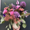 This design includes smoke bush, allium, and clematis, a moody and modern