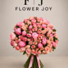 A luxurious hand-tied bouquet of vibrant pink peonies, blush roses, and delicate