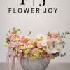 A luxurious arrangement of blush roses, soft yellow spray roses, white orchids