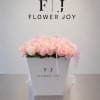 A graceful arrangement of soft blush roses accented with delicate cascading pink