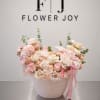 A graceful arrangement of ivory and blush roses, soft hydrangeas, delicate seasonal