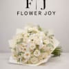 A timeless arrangement of creamy white roses accented with fresh eucalyptus, elegantly