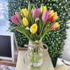 A lively cluster of pink, yellow, and mixed-color tulips creates an instant