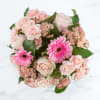 Hand-tied and full-bodied, the bouquet mixes small clusters of pink filler flowers