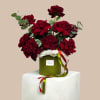 A lush cluster of deep red roses rises from a round green
