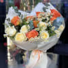 Bouquet of orange and white roses with small white daisies
