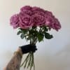 A fresh bunch of premium roses wrapped in simple kraft paper and