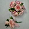 A  pink rose corsage that reads like a whisper of romance-perfect
