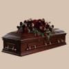 Deep burgundy and red roses and garden blooms form a solemn, elegant