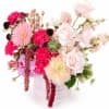 Pale pink roses and hot pink carnations pop against clouds of soft
