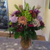 A vase arrangement filled with a assortment of pastel blooms. Suitable for