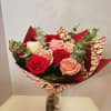Bouquet of red, pink, and white roses in a glass vase
