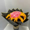 Bouquet of pink carnations and sunflowers in black wrap