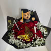 Red rose bouquet with baby’s breath and a graduation teddy bear topper