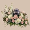 A serene bed of pale pink roses, white hydrangeas, and tall white