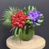 Layered textures of red double tulips and purple Vanda orchids, arranged in