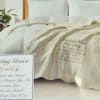 A soft cream quilted coverlet accented with subtle embossed floral motifs sets