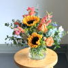 Brighten their day with bright summer blooms. This petite bouquet is arranged
