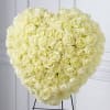Heart-shaped bouquet of cream roses on a stand