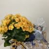 Yellow-orange potted flowering plant with ribbon and gift packaging