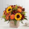 Autumn bouquet with sunflowers, orange roses, and mums in a wooden box