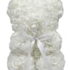 A plush teddy bear shaped entirely from tightly packed white rose blooms