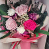 Preserved roses-pale blush, vivid hot pink, and soft lavender-sit at the heart