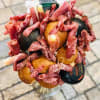 Bouquet made of cured meats and cheese in a clear vase