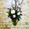 Pink and white peonies in a wine glass vase