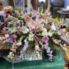 A soft, romantic spray in pastel tones designed to comfort and celebrate