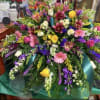 A lush cascade of pink lilies, purple accents, and sunlit yellow and