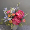 Hot-pink peonies steal the show in this garden-style flower arrangement, balanced by