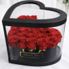 Heart-shaped black box filled with red roses
