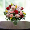 Bouquet of red and pink flowers in a clear glass vase