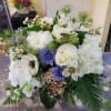 Posey vase container filled with assorted seasonal flowers and greens. 
**Low compact