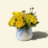 Bright yellow roses and sunny yellow chrysanthemums create an instant lift in