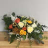 Mixed bouquet with orange, yellow, and white roses in a wooden box