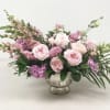 Pink and lavender floral arrangement in a silver vase