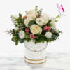 Delicate and timeless, this luxurious arrangement features elegant white roses, soft blush