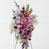 Tall standing spray of pink lilies and lavender flowers